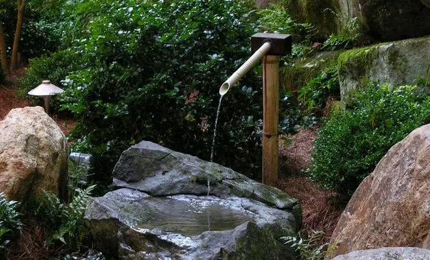 Well-Planted Boulders And A Tsukubai Water Feature Add Structure And Beauty To A Japanese-Inspired Garden