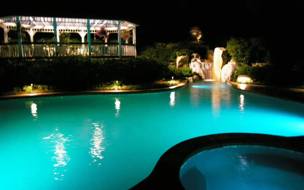 Swimming Pool And Waterfall With Custom Lighting
