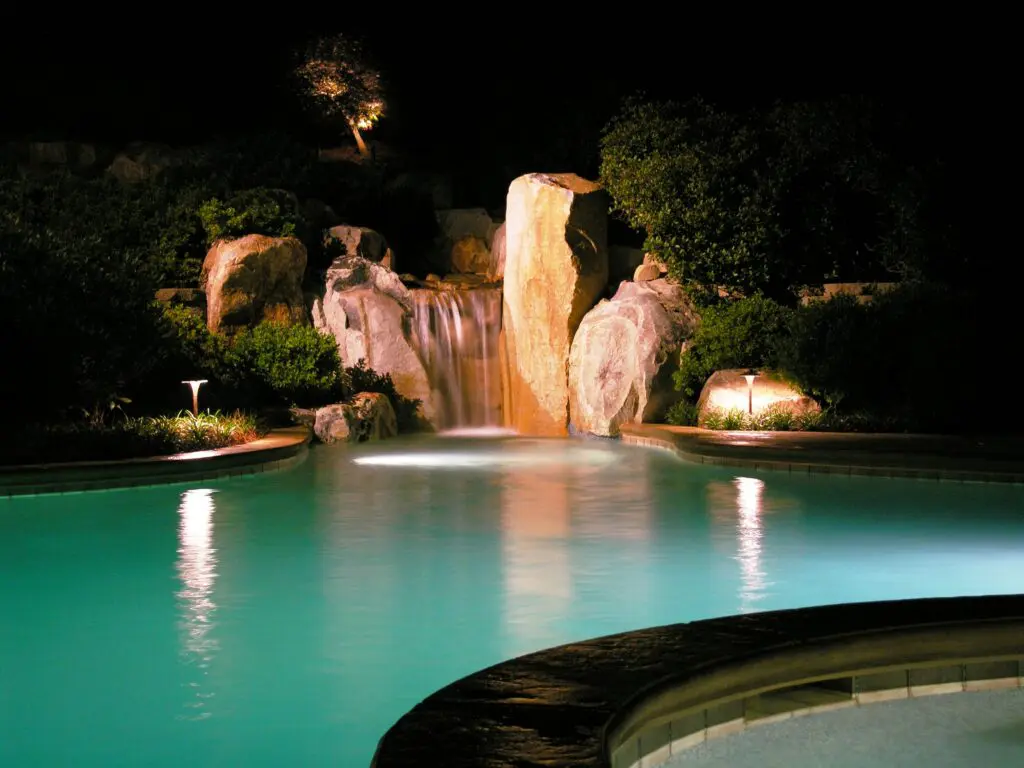 Swimming Pool And Waterfall With Custom Lighting