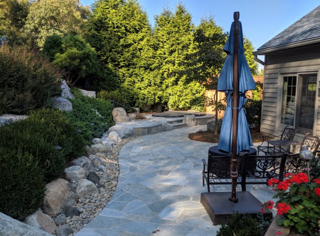 A Patio With Natural Stone Paving On A Concrete Base Designed And Installed In Lancaster, Pa By Hanselman Landscape Backyard Patio Contractors.