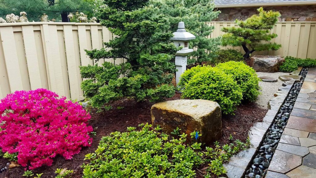 A Backyard Zen Garden With A Stone Japanese Latern