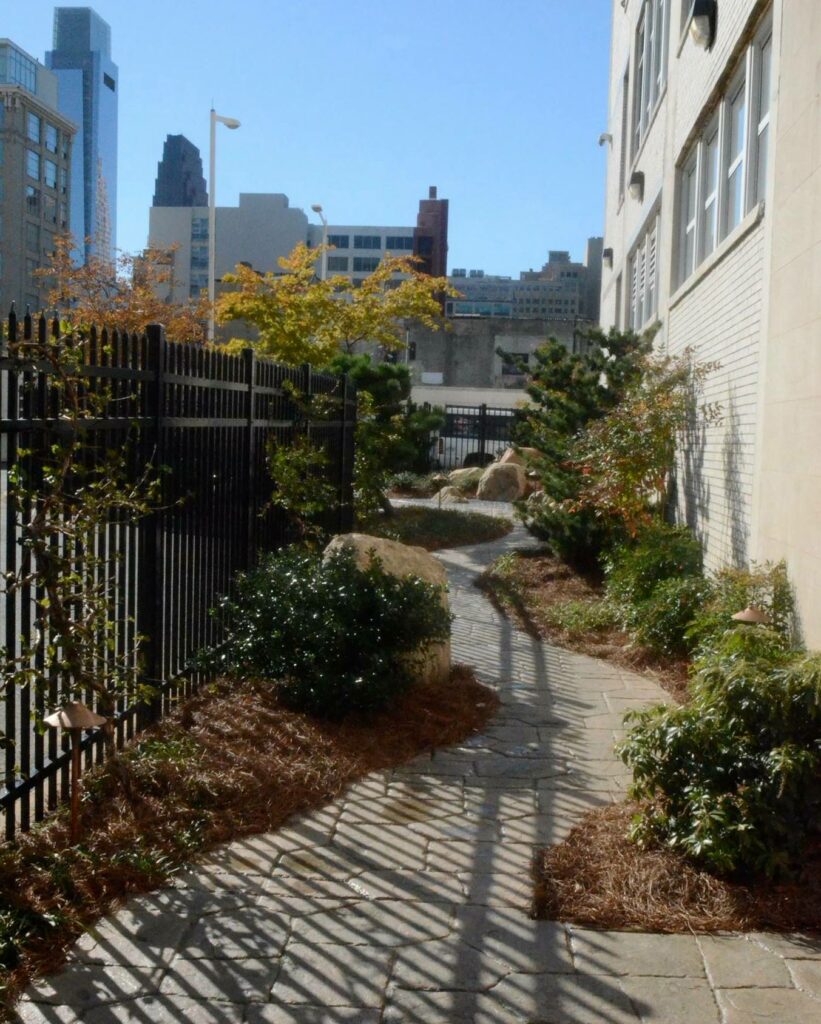 A Path Winds Through A Narrow Courtyard Garden At An Apartment Complex In Philadelphia, Pa.