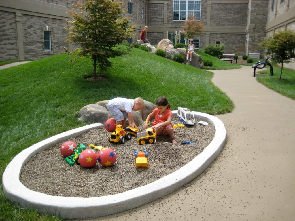 Kids Playing In A Commercial Courtyard Garden Designed And Installed By Hanselman Gardens In Lancaster, Pa