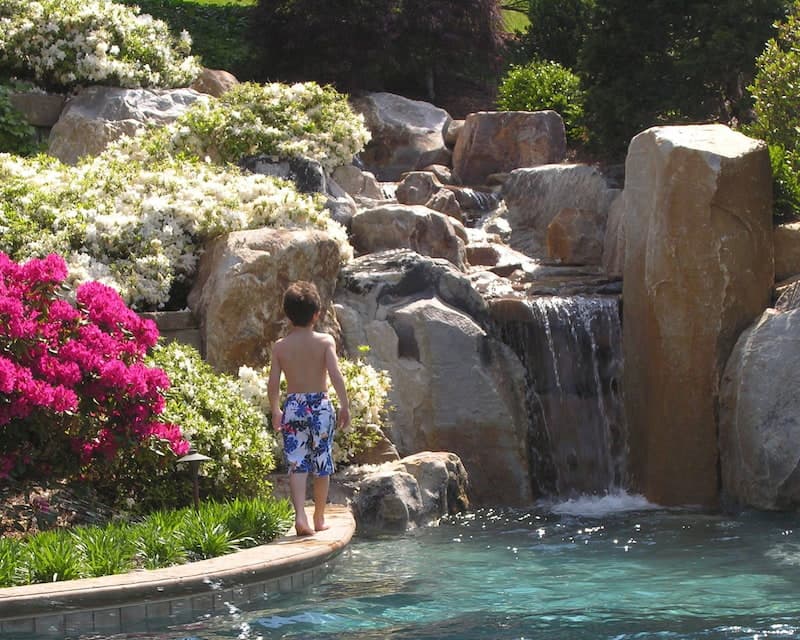 A Child Ready To Explore A Waterfall That Is A Part Of A Children'S Garden Designed And Installed By Hanselman Landscape And Gardens